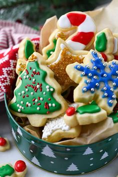 a bowl filled with christmas cookies on top of a table