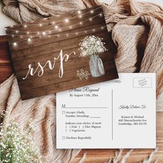 the rustic mason jar and string lights wedding stationery is displayed on top of a wooden table