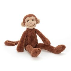 a brown stuffed monkey sitting on the ground