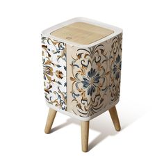 an artisticly designed cabinet with wooden legs and wood handles on the sides, decorated with flowers