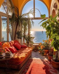 a living room filled with lots of furniture and plants on top of a red rug