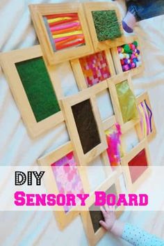 a child is playing with some toys on the bed and it says diy sensory board