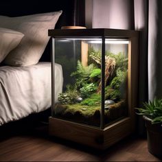 an aquarium is sitting on the floor next to a bed