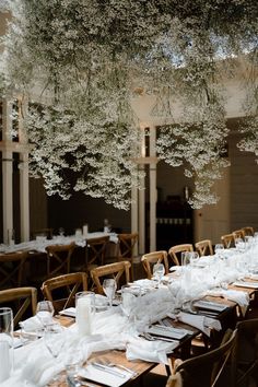 the tables are set with white plates and place settings