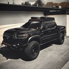 a black truck parked in front of a building