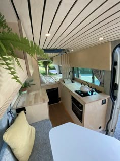 an interior view of a camper with the kitchen and living area