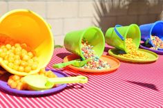 three buckets filled with cereal sitting on top of a table