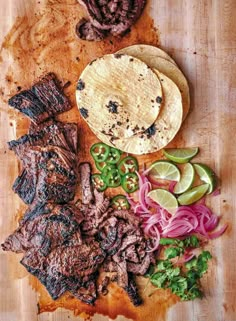 steak and tortillas on a cutting board