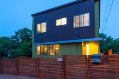 a house that is next to a wooden fence