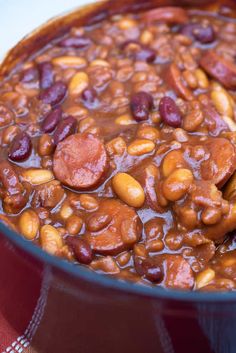 a red pot filled with beans and sausage