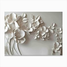 paper flowers are arranged on the wall in an artistic manner with white and gray tones