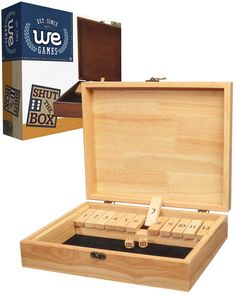 an open wooden box with dominos in it next to a card board game case