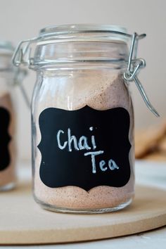 two glass jars filled with different types of tea