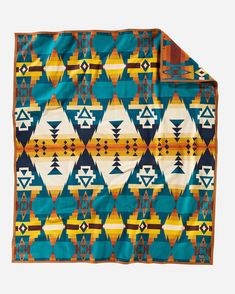 an orange, blue and yellow blanket with geometric designs on the bottom half of it