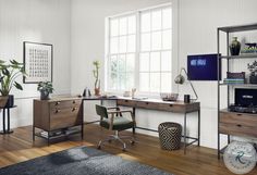 a home office with a desk, chair and potted plant in front of the window