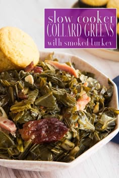 a white bowl filled with collard greens next to bread