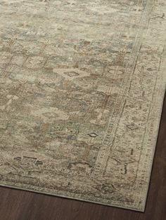 an area rug with wooden flooring on top of it and a wood floor in the background