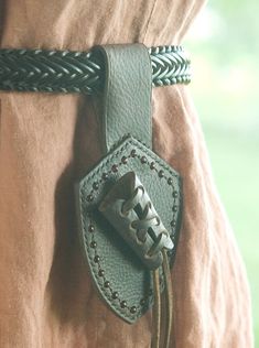 a belt with a metal buckle on it and some braiding around the clasps