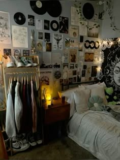 a bed room with a neatly made bed and lots of pictures on the wall