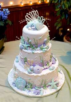 the wedding cake is decorated with sea shells