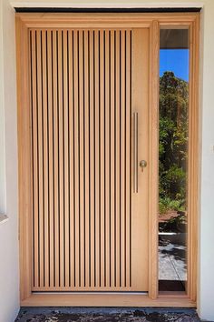 the front door is made of wood and has vertical slats