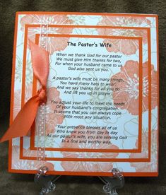 an orange and white card with a poem written in the center on top of it