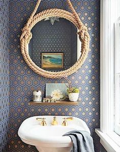 a white sink sitting under a mirror next to a window