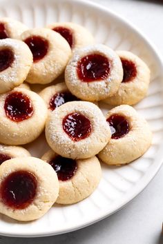 This recipe for one-bowl cream cheese thumbprint cookies features such simple ingredients, but the taste is anything but! An easy, quick-chilling dough bakes up perfectly tender and soft with a pool of raspberry jam in the center. They're a family favorite holiday cookie. Christmas Baking Thumbprint Cookies, Thumbprint Cookies Sallys Baking, Cheesy Thumbprint Cookies, Thumb Print Cookies With Cream Cheese, The Best Thumbprint Cookies Recipe, Raspberry Cream Cheese Thumbprints, Ina Garten Thumbprint Cookies, Thumbprint Cheesecake Cookies, Christmas Cookie Thumbprint