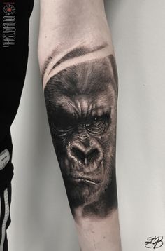 a man's arm with a gorilla tattoo on it