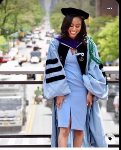 a woman in a graduation gown and cap