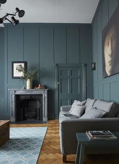 an image of a living room with blue walls and wood flooring in the background