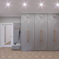 a room that has some metal lockers on the wall and lights above it,