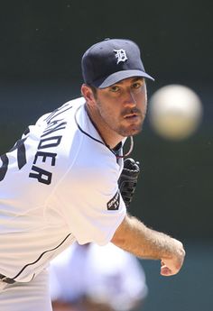 a baseball card with a player throwing a ball in the middle of his arm and wearing a hat