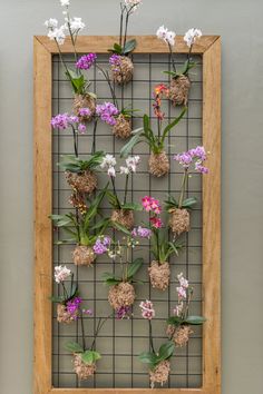 a wooden frame with flowers hanging on it