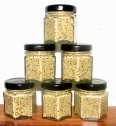 six jars are stacked on top of each other with black lids and gold flecks