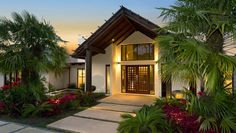 a house that is surrounded by plants and trees