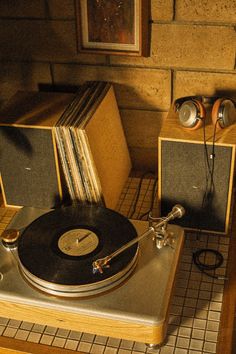 an old record player sitting on top of a table