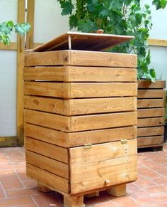 a wooden planter sitting on top of a brick floor