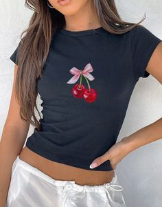 Introducing our Cherry Bow Art Baby Tee, a trendy blend of coquette aesthetic cherry-inspired style. Made from 100% premium cotton, this tee offers a luxuriously soft feel and a 90's/Y2K fit that ensures comfort all day long. Designed with a high-quality print, the Cherry Bow Baby Tee showcases a captivating bow motif and juicy cherries that adds a touch of girly elegance to any outfit. Our Baby Tee is crafted using the Gildan 5000b, a youth-sized shirt designed to authentically emulate the classic 90s/Y2K Baby Tee look. Whether paired casually with jeans or dressed up with a skirt, this tee seamlessly integrates into any wardrobe, making it an ideal choice for gifting. Embrace the allure of the coquette aesthetic with our thoughtfully crafted tee, where comfort meets fashion in every deta Coquette Cherry, Cherry Art, Sabrina Carpenter Outfits, Bow Art, Trendy Bows, Bow Coquette, Fits For Summer, Y2k Baby Tee, Art Shirt