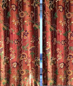 an orange curtain with floral designs on it