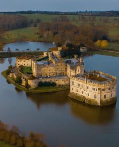 an aerial view of a castle in the middle of a lake