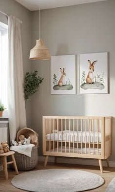 a baby's room with two pictures on the wall and a crib next to it