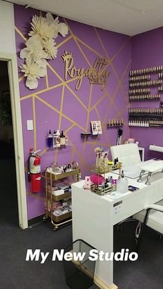 a beauty salon with purple walls and gold accents