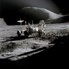 an astronaut on the moon next to a vehicle