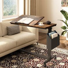 a living room with a couch, coffee table and rugs on the floor in front of a window