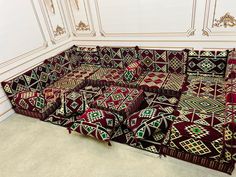 a large group of couches are arranged on the floor in a room with white walls