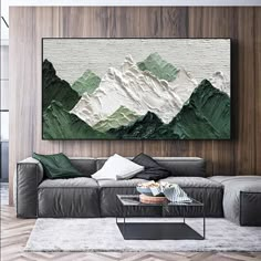 a living room filled with furniture and a large painting on the wall above it's couch