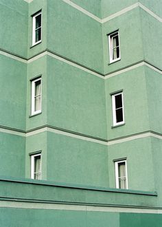 a large green building with many windows