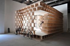 a bike is parked in front of a wooden shelf with bookshelves on it