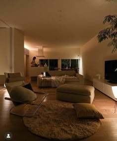 a living room filled with furniture and a flat screen tv on top of a wooden floor